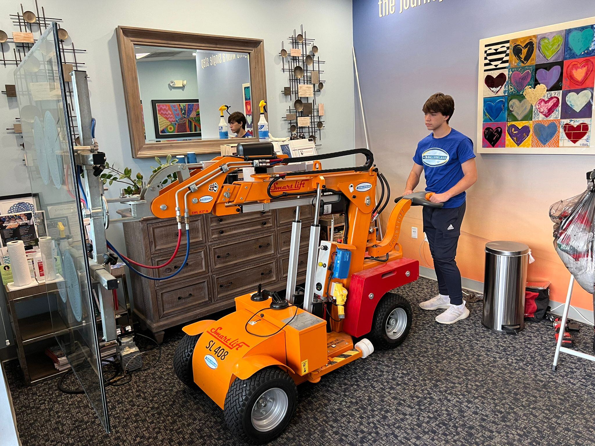 Ballistiglass crew member operating a Smartlift SL408 glass lifter inside Eagles’ Haven, Coral Springs, FL — a wellness center for families affected by the events of February 14, 2018, installed in partnership with JAFCO.