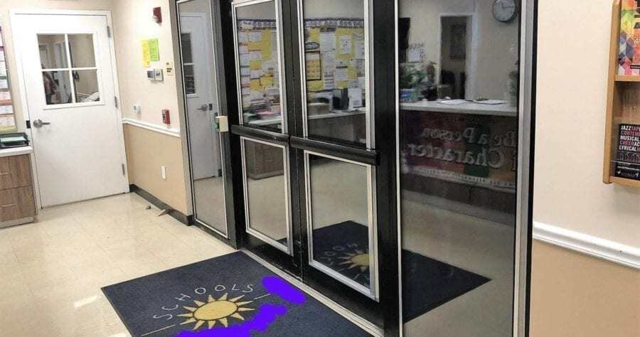 BallistiMAX glass doors at a school entry — ballistic glazing installed in the existing storefront frames.